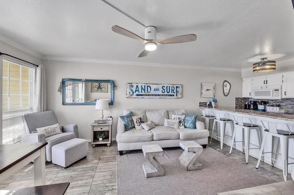 Bright coastal living room with open kitchen and spacious breakfast bar