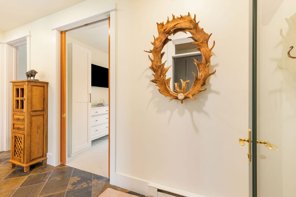 Step into your mountain retreat through a welcoming hallway adorned with rustic charm and unique artisan touches that set the tone for your stay.