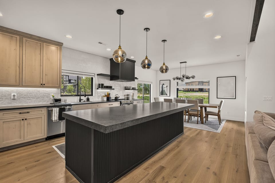 Bright designer kitchen with oversized island and airy dining area