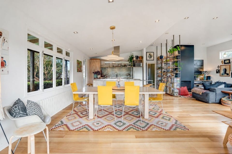 Open-plan living and dining filled with art and character