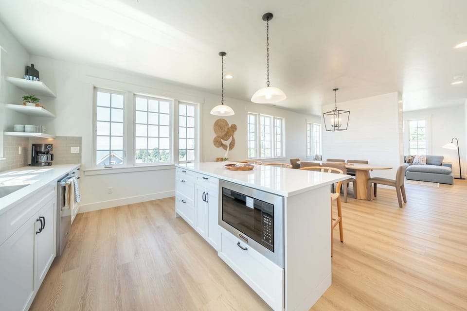 Bright open kitchen with island and stainless-steel appliances