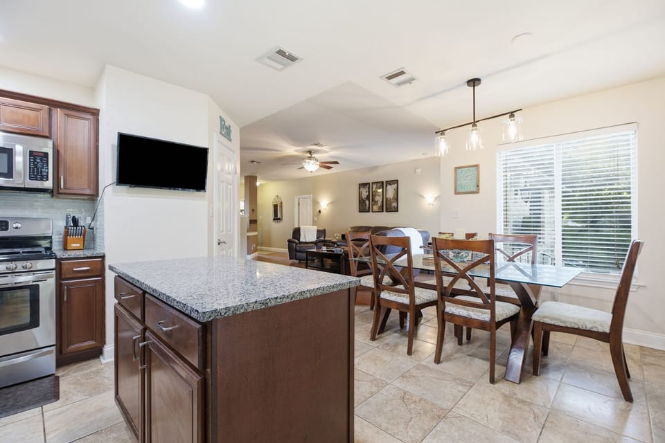 Bright open kitchen and dining area with granite island and seating for 6