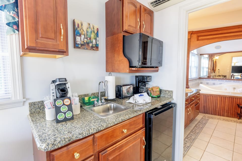Kitchenette area with microwave, mini fridge, Keurig, and toaster