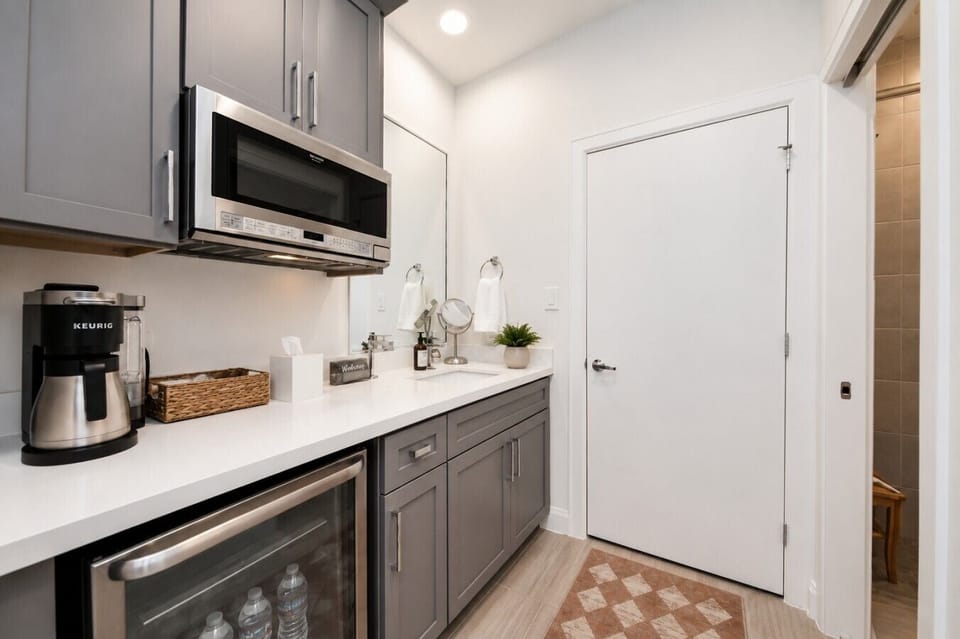 Enjoy the convenience of a private coffee bar, beverage fridge, and kitchenette—perfect for extended stays or quick refreshments