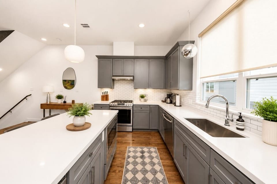 Modern chef’s kitchen with quartz countertops, stainless steel appliances, and a spacious island