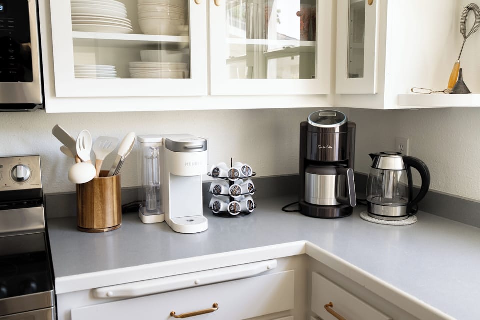 Bright kitchen with coffee station, kettle, and clean modern counters