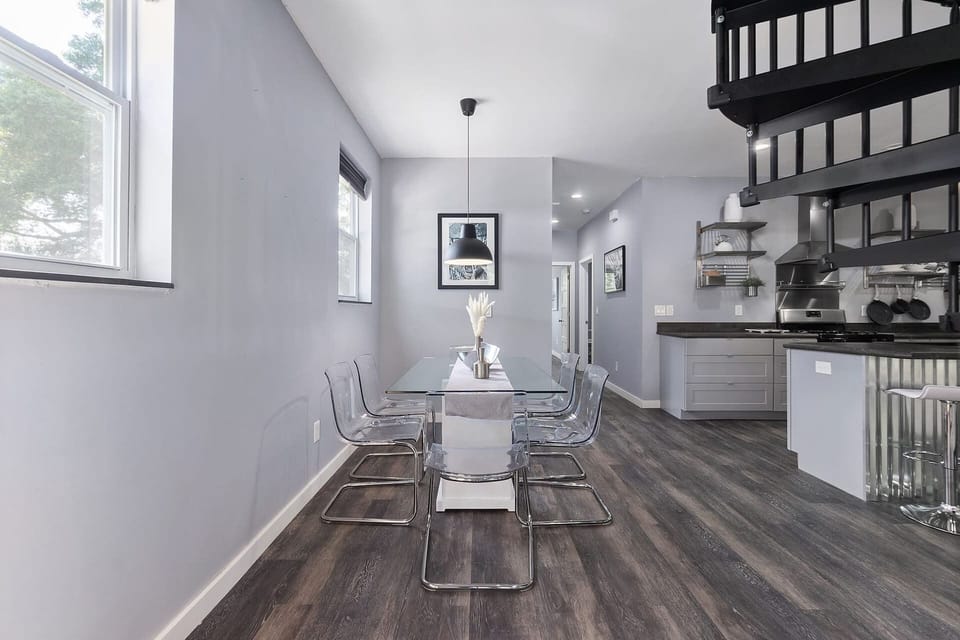 Modern open dining space with stylish kitchen and striking spiral staircase