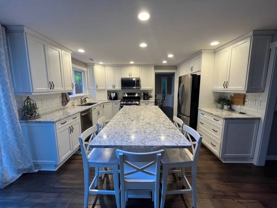Renovated kitchen with gas range and island seating