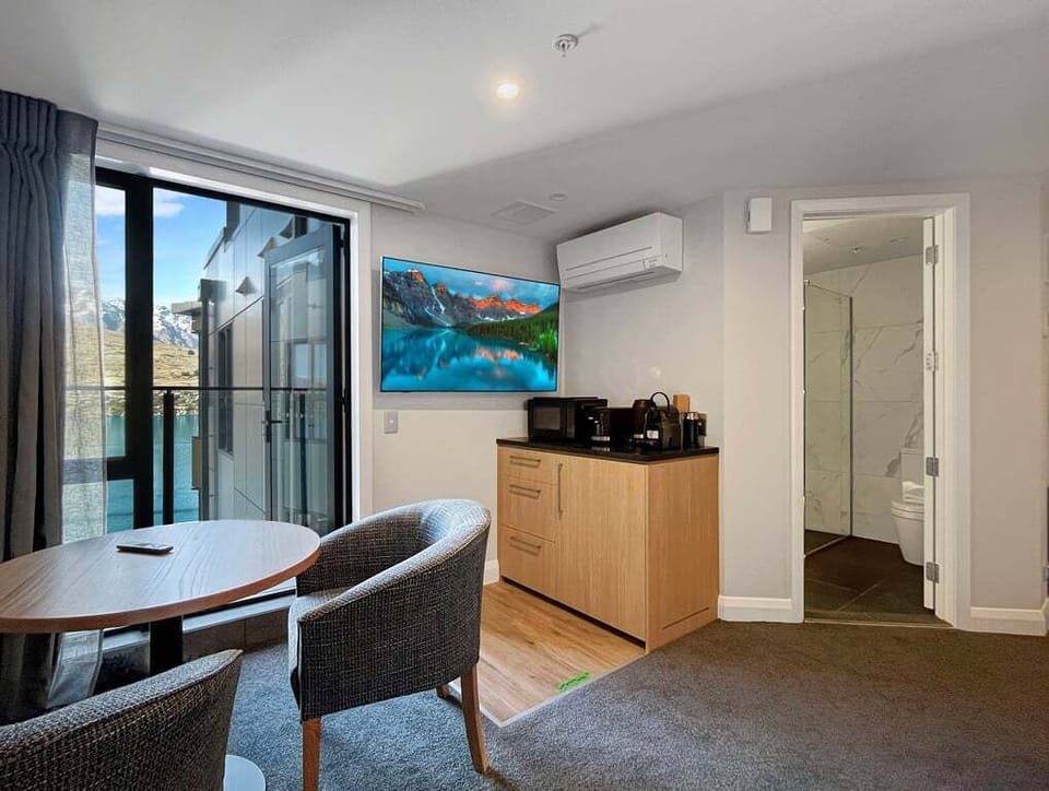 Bright studio with a cosy dining area and kitchenette for easy self-catering.