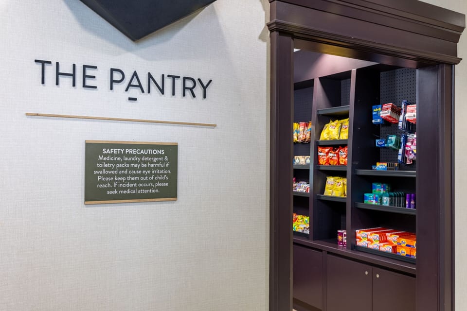 Pantry area with shelved snacks, sundries, and packaged convenience items.