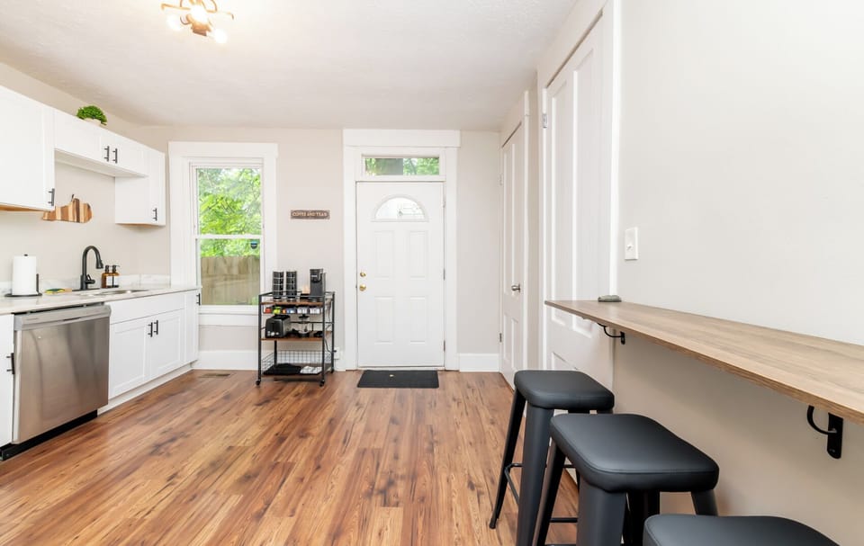 Leave your kitchen tools organized on the black metal utility cart near the door. The wide walkway makes it simple for multiple people to cook together.