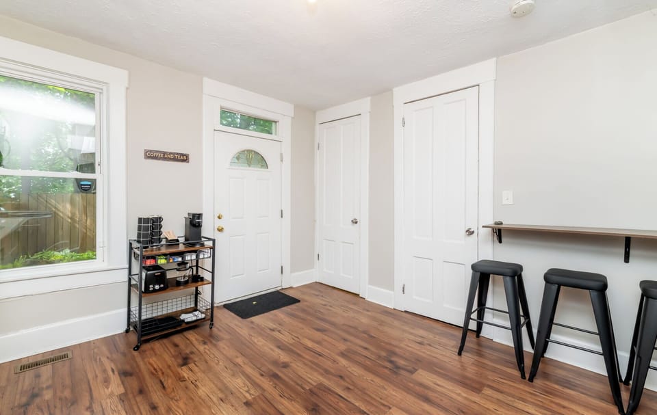 Roll the handy black cart around the kitchen to help serve your tasty meals. The bright white back door leads straight out to the fun patio.