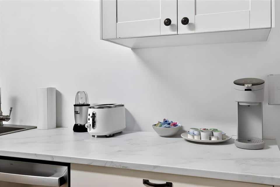 Brew a fresh cup of morning energy using our simple coffee pod machine or the toaster. The gorgeous white marble style counter makes breakfast prep a joy.