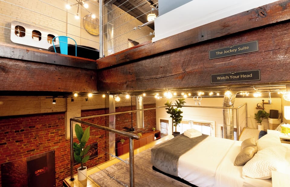 Lean over the metal railing to see the awesome living space below. The giant historic brick walls look truly spectacular from up here.