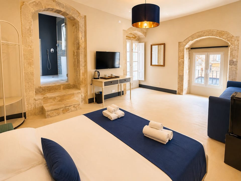 Deluxe Quadruple Room | Minibar, in-room safe, desk, laptop workspace
