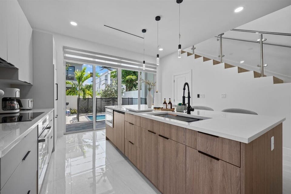 Bright dining area with wooden table and sleek contemporary chairs.