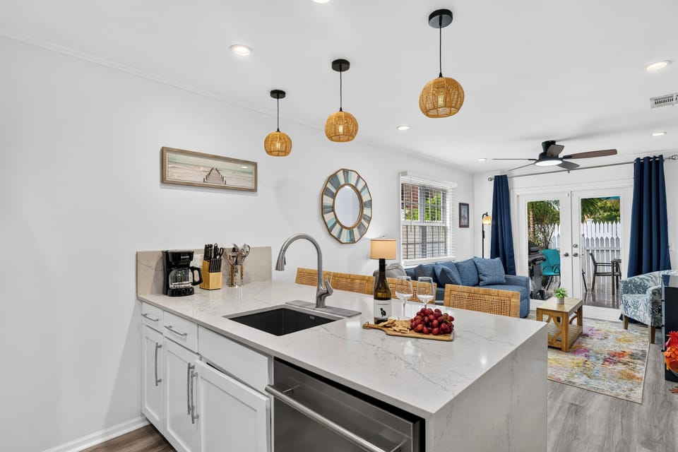 Angle showing the kitchen counter setup, modern appliances, and adjacent dining area.