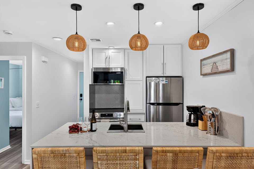 Close-up view of the kitchen island, sinks, and pendant lights.