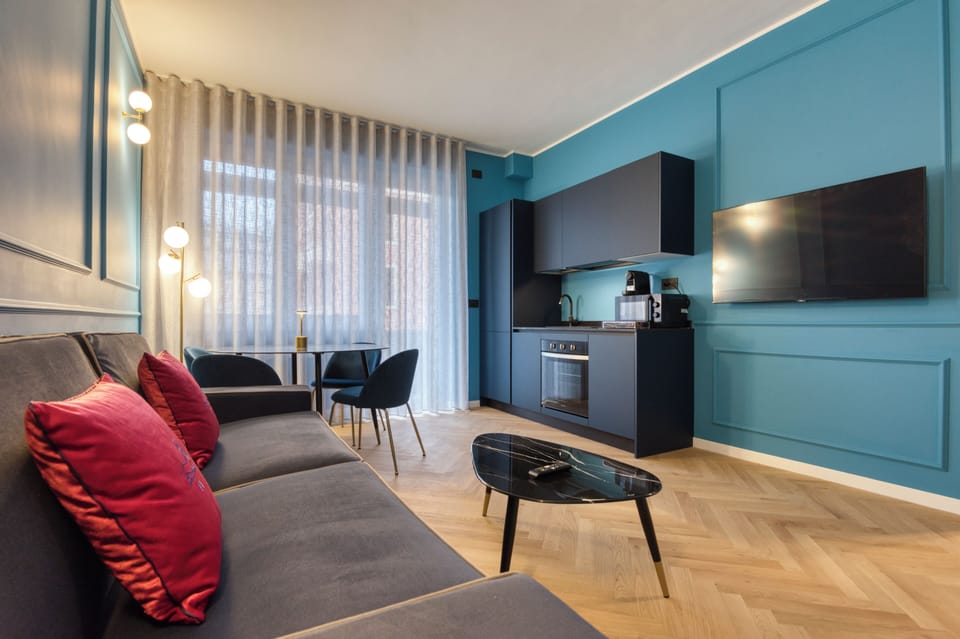 Deluxe Apartment, Balcony, City View | Living area | 50-inch Smart TV with cable channels