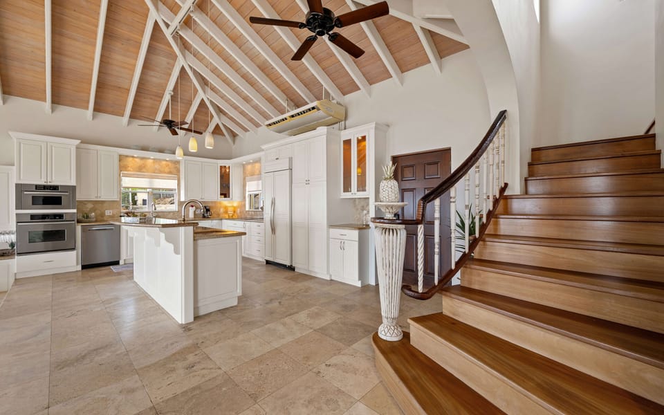 Staircase that leads to the two upper king bedroom suites.