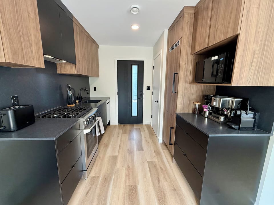 Full kitchen, dishwasher, range, microwave, coffee machines, knives, fridge, front entrance closet. 