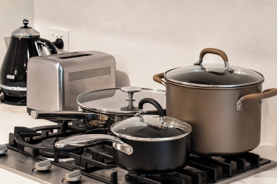 Well-equipped kitchen with gas cooktop, cookware, kettle, and toaster