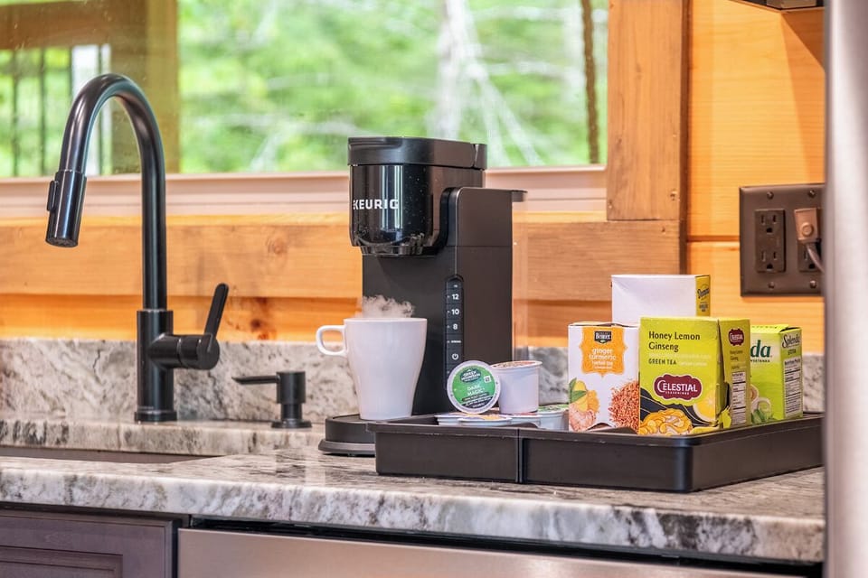 Start your mornings with fresh coffee or tea from the Keurig, stocked with a variety of flavors for you to enjoy. Large windows frame a peaceful green view while you sip and unwind.