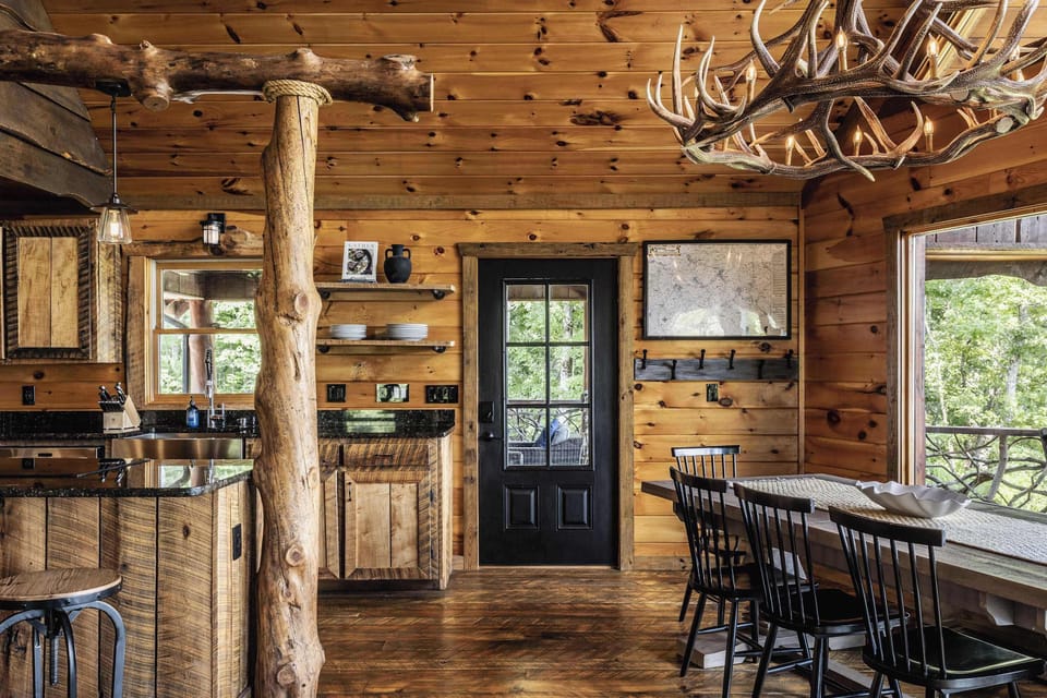 Gather the group around the farmhouse-style table for family dinners, antler chandelier included.