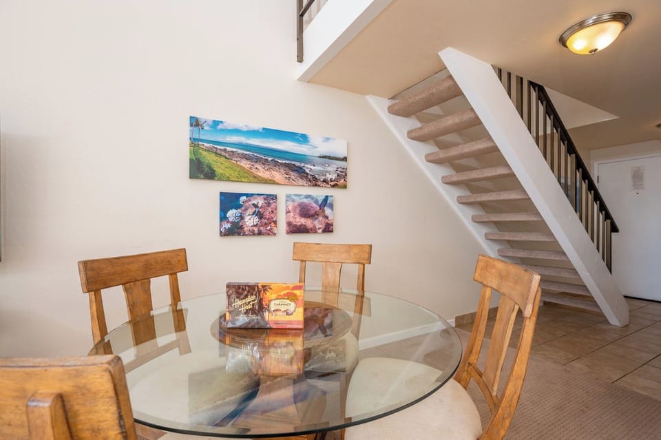 This sunny dining space offers lofted ceilings, modern tropical decor, and a cozy spot to enjoy meals and moments NAP-C18
