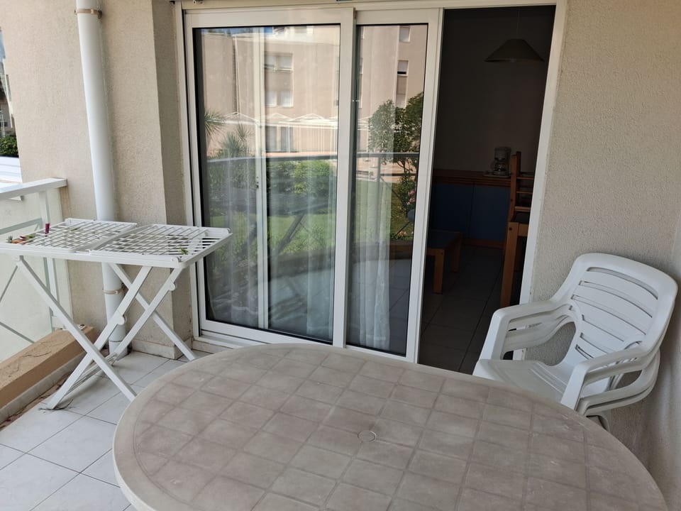 Step out onto the balcony with a table and chair — the beach is just 200 m away on foot
