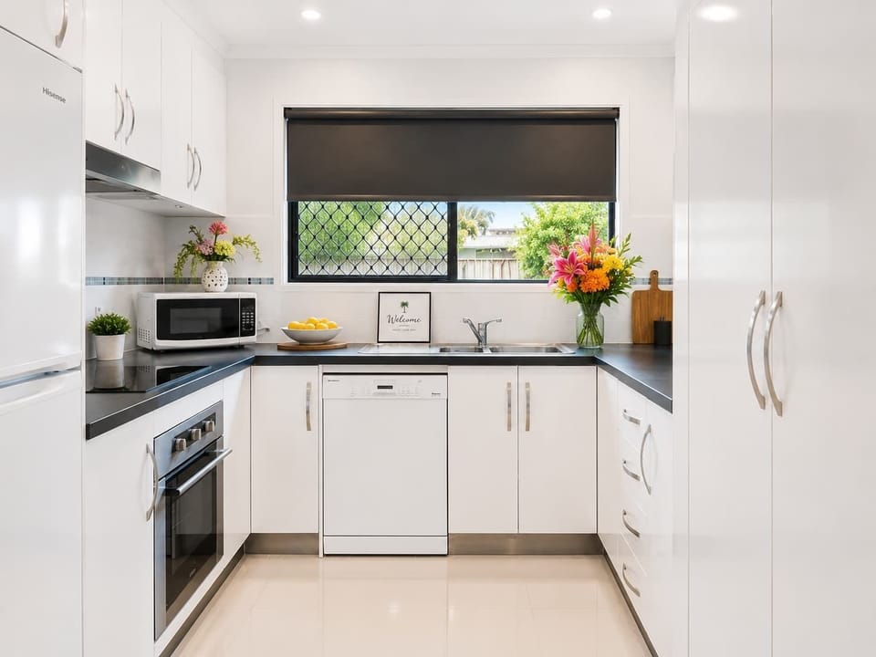 Prepare meals with ease in the fully equipped kitchen featuring modern appliances, a dishwasher, generous bench space and everything you need for a comfortable stay.