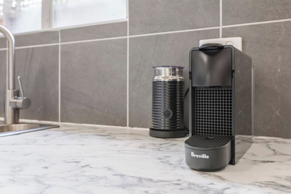Start the day right with a fresh brew from the Nespresso machine and milk frother, perfectly positioned for quick access.