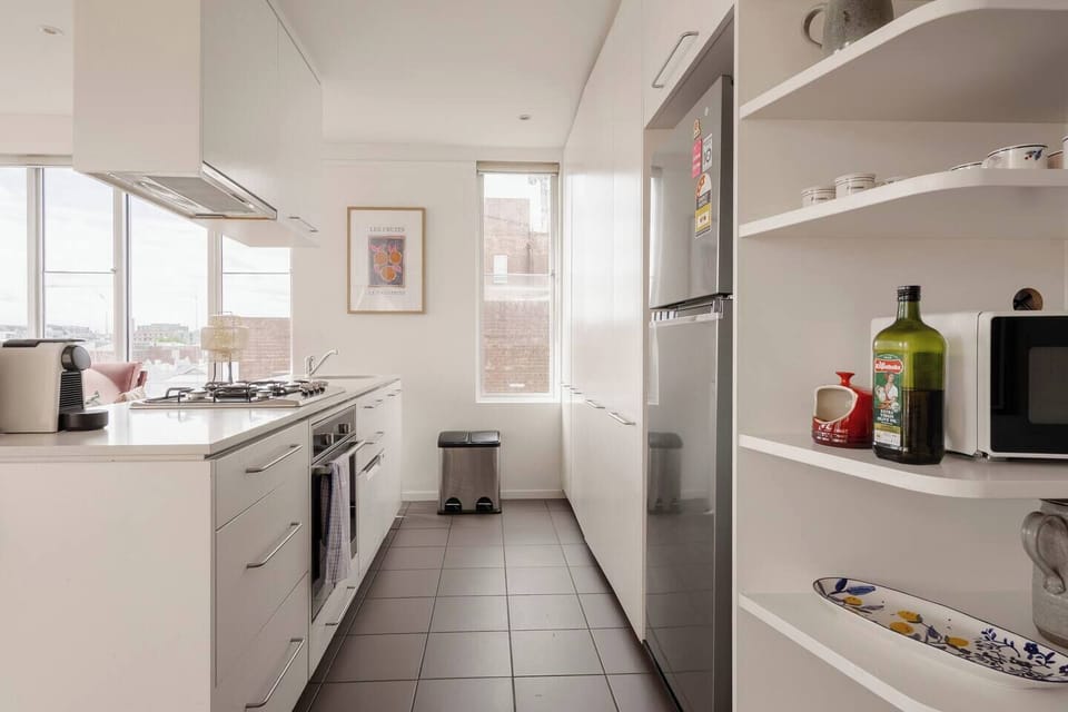 Cook with ease in the modern kitchen complete with a gas stove, oven, microwave, fridge, dishwasher, pantry basics, a French press, and a Nespresso machine for fresh coffee.