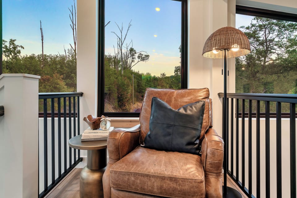 Claim the leather chair by the window—your quiet corner for sunset views.