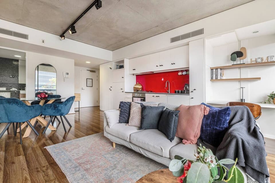 The open-plan design connects the living, dining, and kitchen zones, creating a warm and cohesive flow ideal for relaxation or conversation.