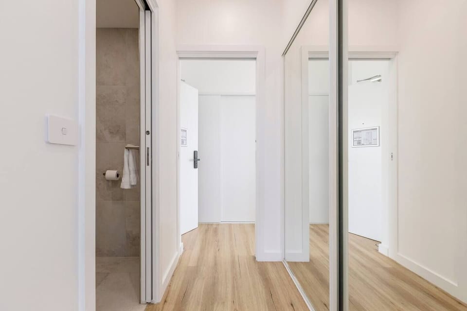 A mirrored built-in wardrobe in the primary bedroom provides generous, discreet storage.