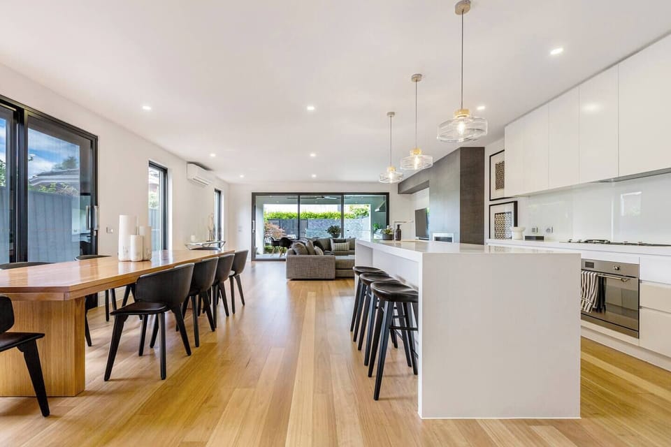 The indoor dining area sits beside the kitchen, offering a relaxed space for long dinners and easy family breakfasts.