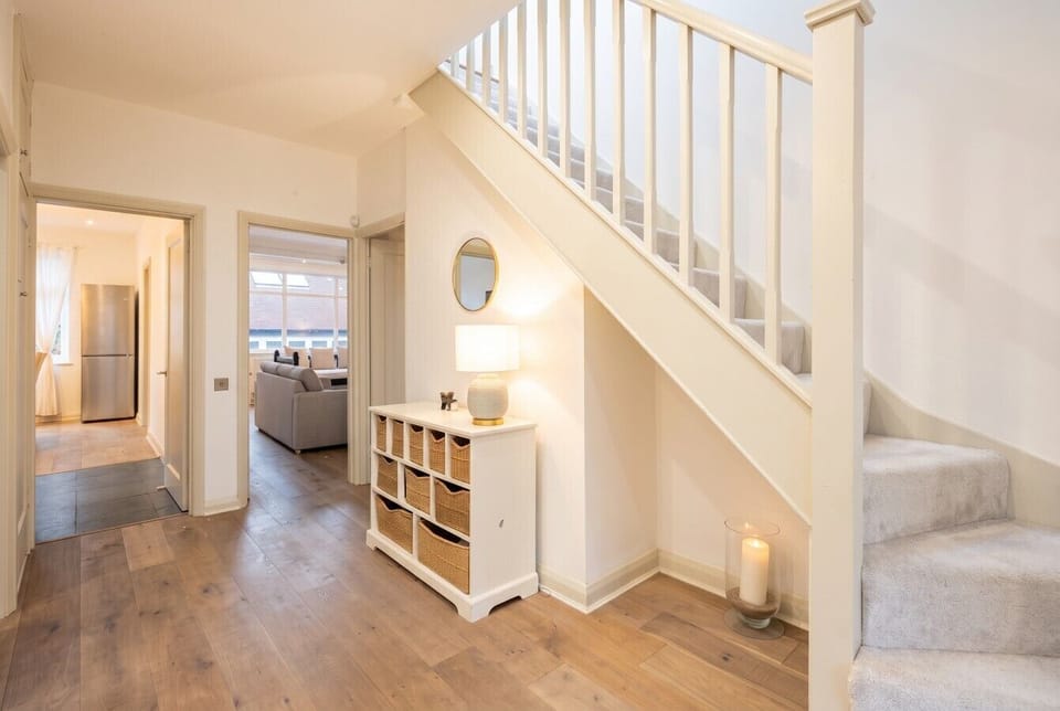 Charming entrance hall with cosy candlelight and handy storage baskets.