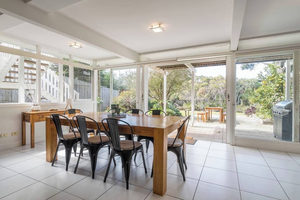 Enjoy seamless indoor-outdoor living, with the dining area opening directly onto the leafy patio for effortless alfresco meals and garden views.
