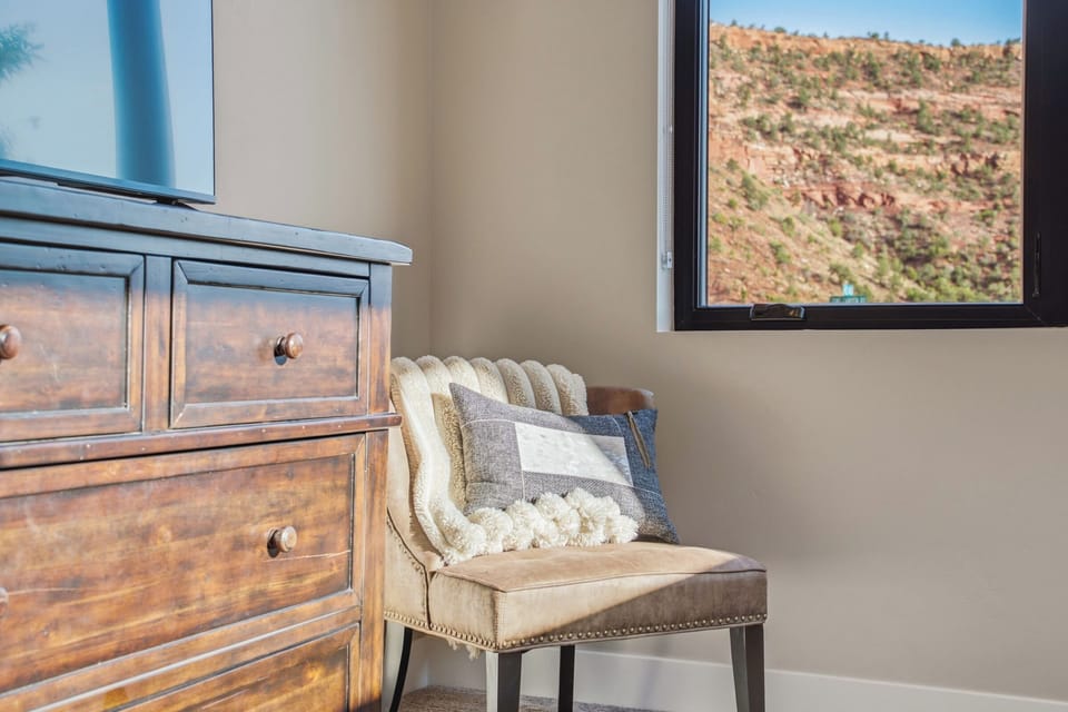 Curl up in this window-side chair with cushions and soak in the red rock scenery from Grand Kanab'n.