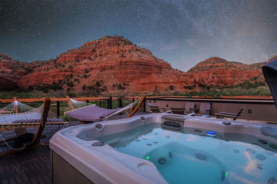 Soak under the stars in the rooftop hot tub with red rock views at Grand Kanab'n