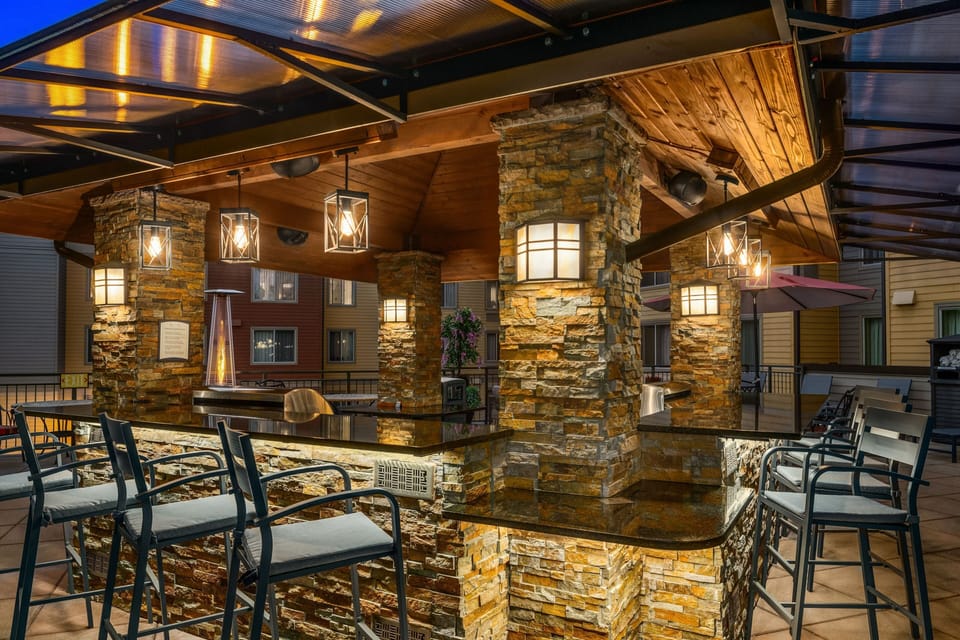 Pull up a stool at the stone bar counter, warmed by a patio heater as evening sets in