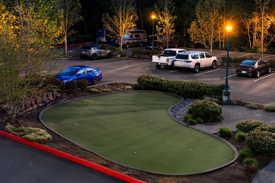 Take on the five-hole putting green, framed by trimmed hedges and landscaping