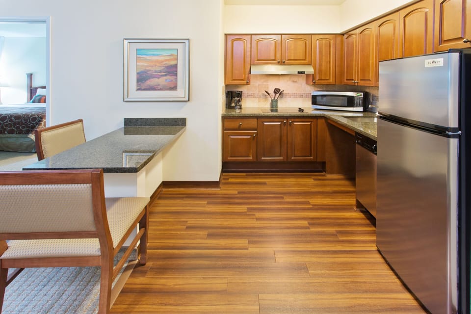 Functional kitchen area with modern appliances and seating.