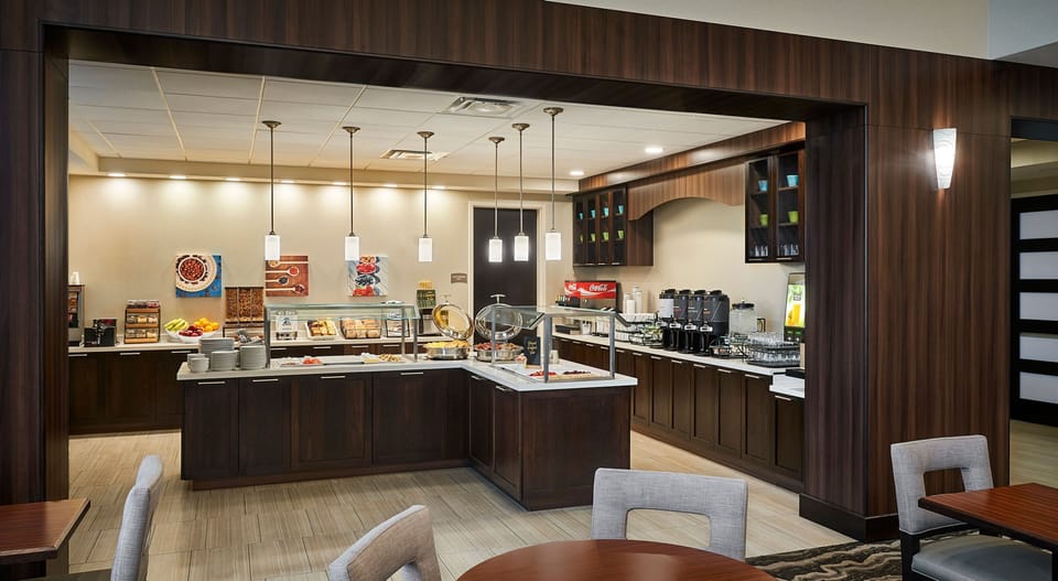 Breakfast buffet area with food display and seating.