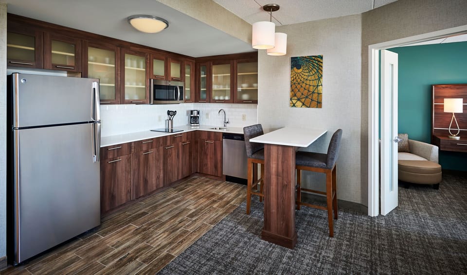 Kitchen with stainless steel appliances and bar seating.