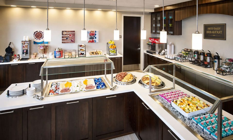 Buffet-style breakfast area with pastries and offerings.