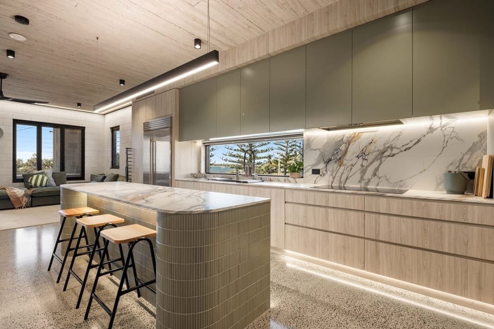 Kitchen runs the length of the room, marble island, water through the window