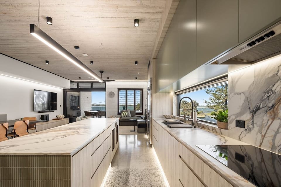 Sightline down the kitchen to the living room and out to the water