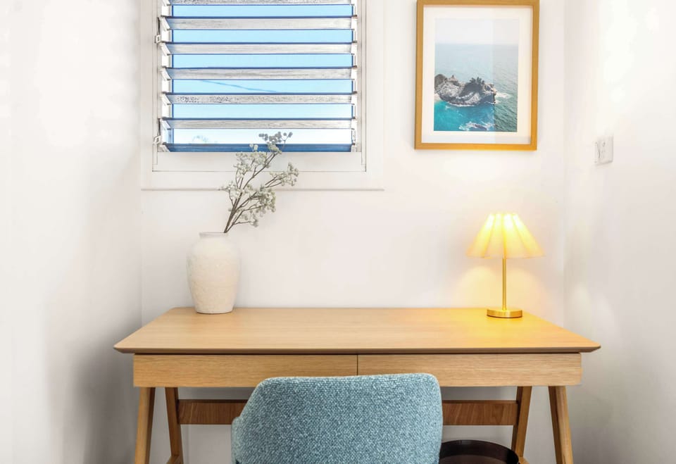 Dedicated upstairs desk provides a convenient workspace during your beachside stay